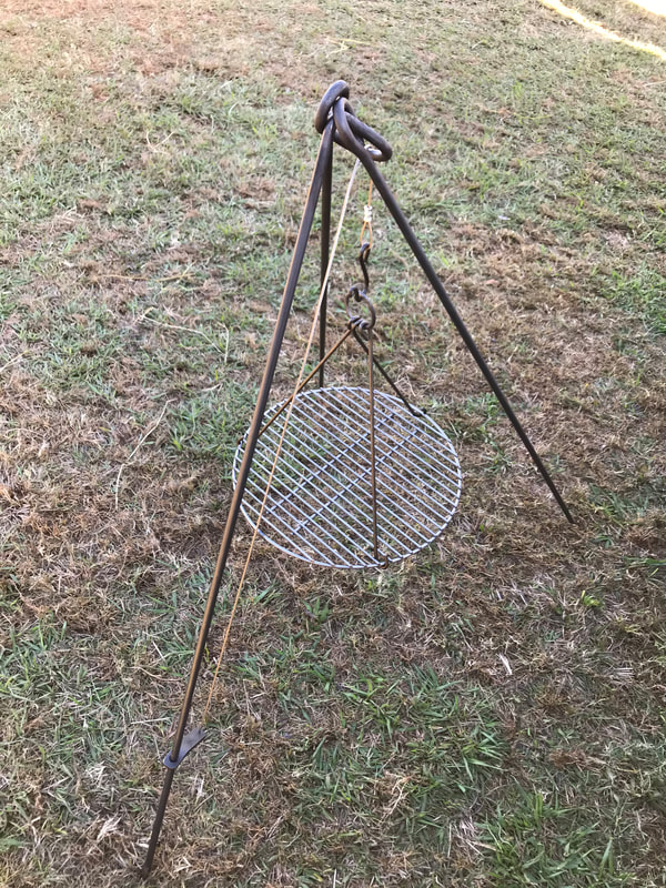 Camping tripod includes adjustable grill. Grill can be removed to hold coffee pot or Dutch oven. Great over a fire pit.